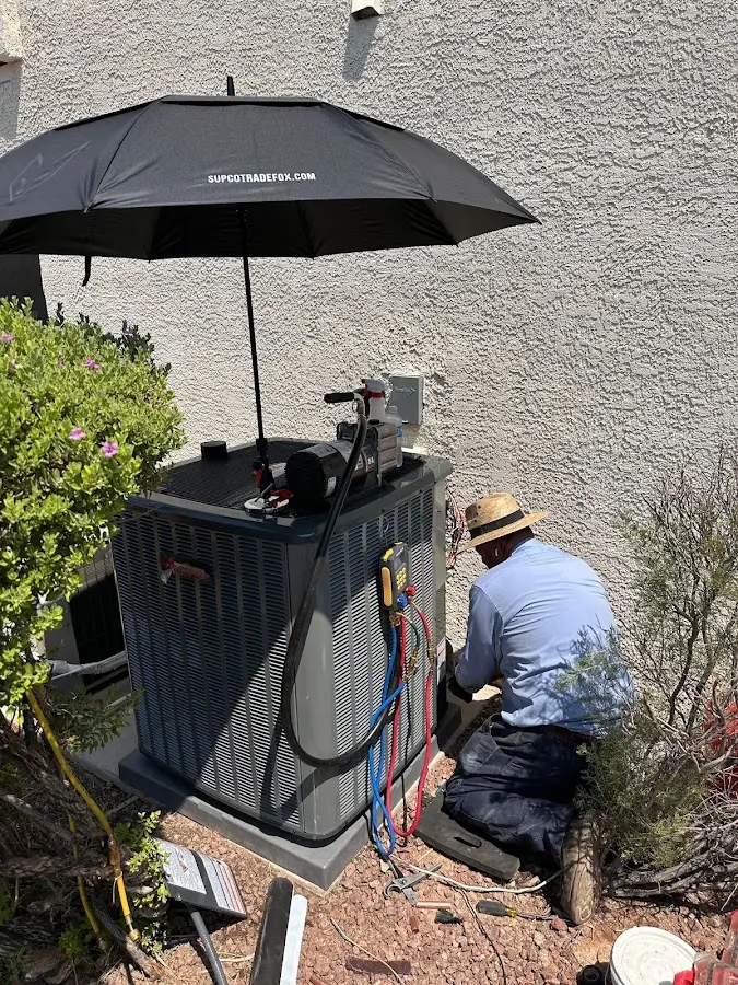 HVAC technician performing outdoor AC maintenance in Black Jack